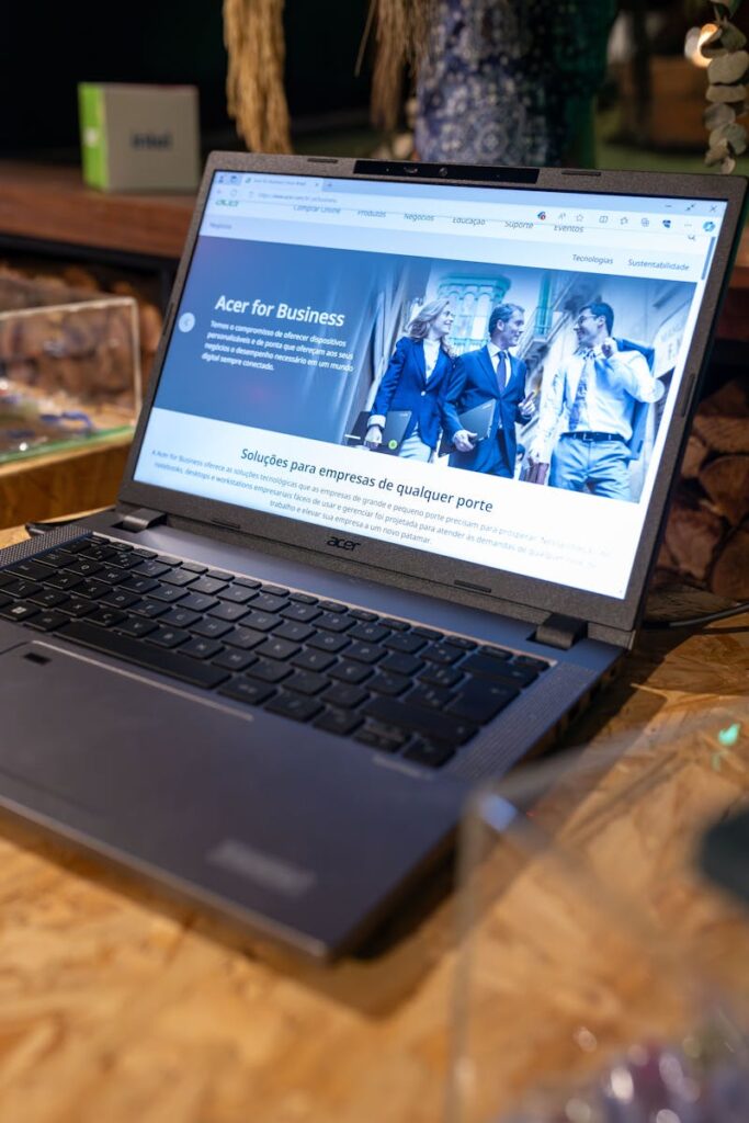 pexels-photo-26150604-26150604 An open Acer laptop displaying a business webpage, set on a wooden desk indoors.